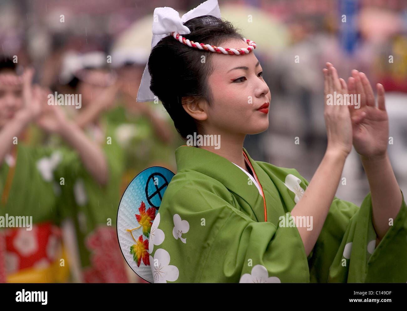 Women in green yukata kimono dancing in symmetrical lines during the Ohara Matsuri dance festival in Kagoshima City, Japan. Stock Photo