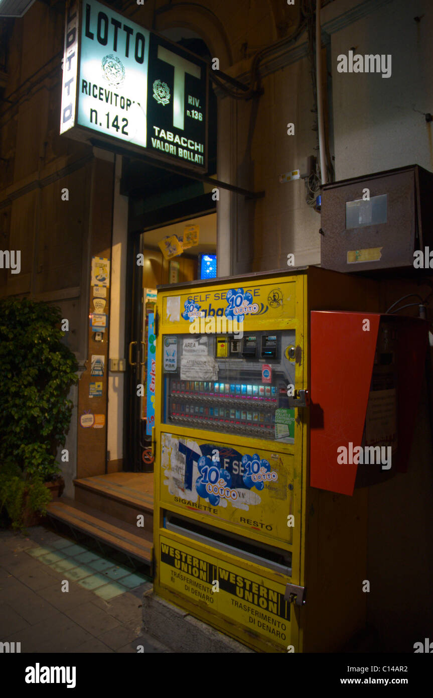 Tobacco self service vending machine outside lotto and tabacchi kiosk at night central Messina city Sicily Italy Europe Stock Photo