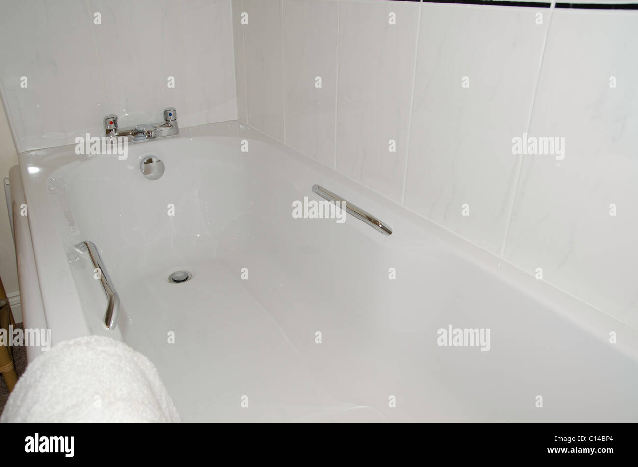 White bath with chrome fittings Stock Photo