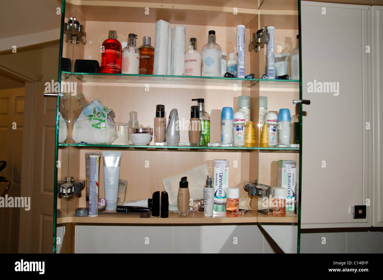 Bathroom detail with a distressed metal storage cabinet topped with  toiletries in glass jars Stock Photo - Alamy