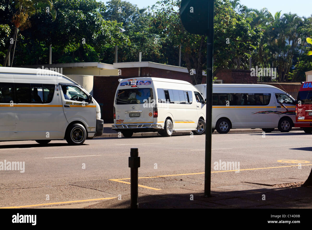 Minibus taxis offloading early morning commuters. Durban, KwaZulu Natal, South Africa. Stock Photo