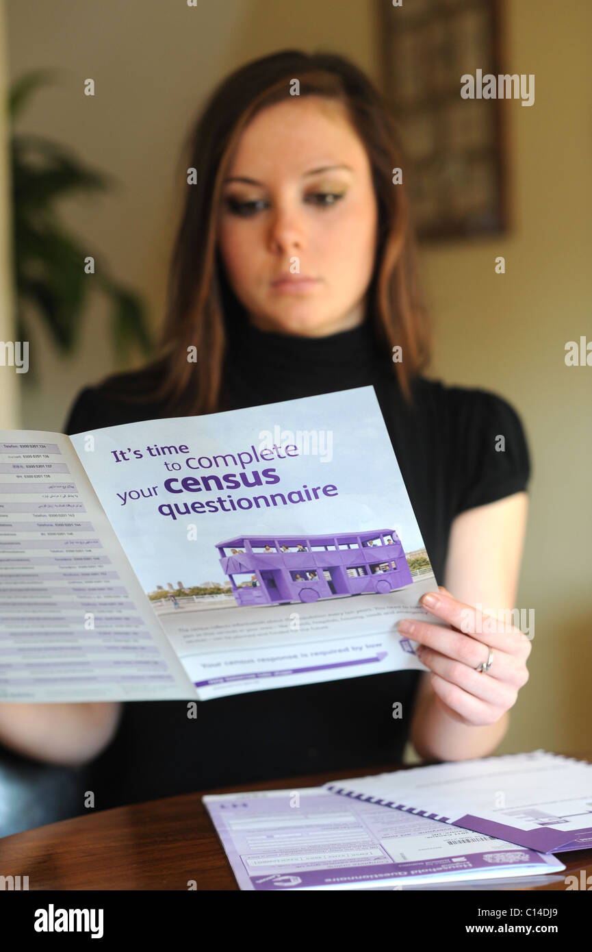 Young woman reading instructions on how to fill out the census form for England UK 2011 - posed by model Stock Photo