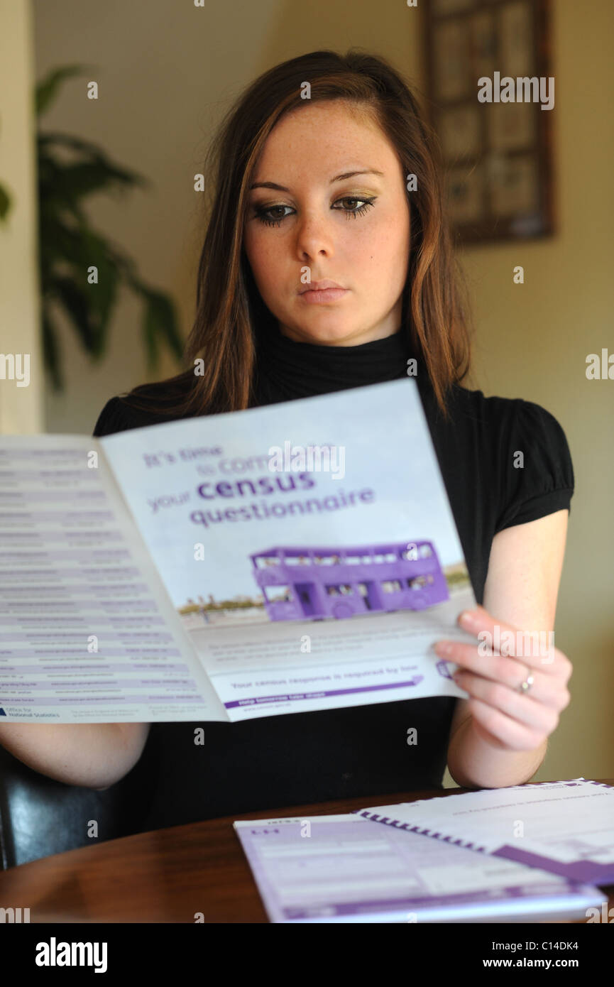 Young woman reading instructions on how to fill out the census form for England UK 2011 - posed by model Stock Photo