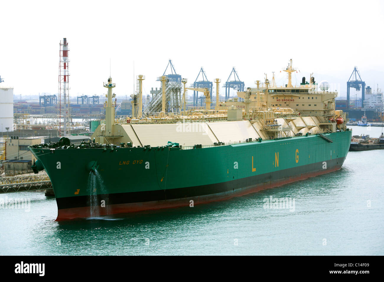 LNG tanker OYO alongside Barcelona Harbour dischaging cargo Stock Photo
