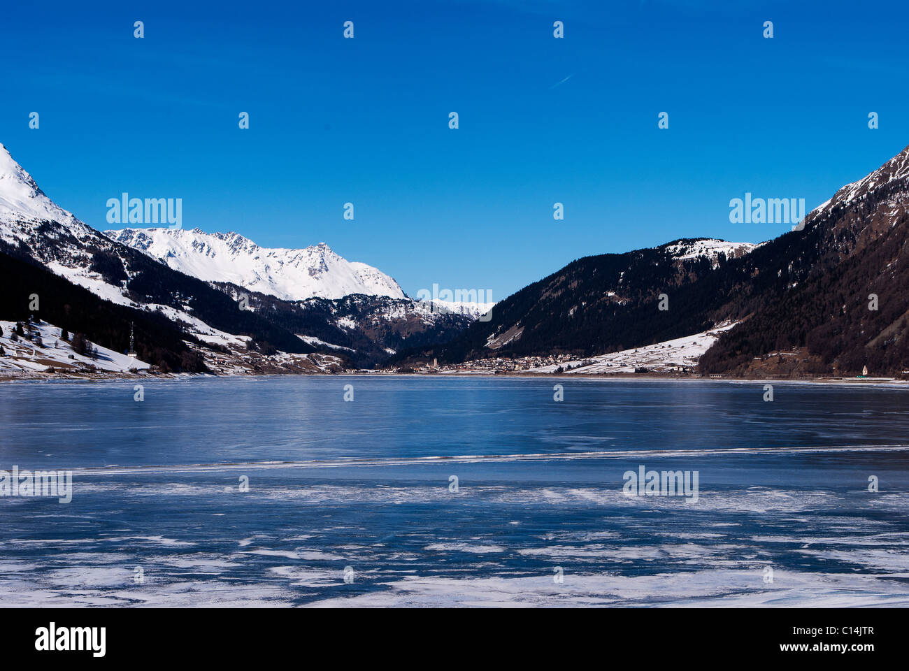 frozen lake in winter with the Alpine mountains and blue sky Stock ...