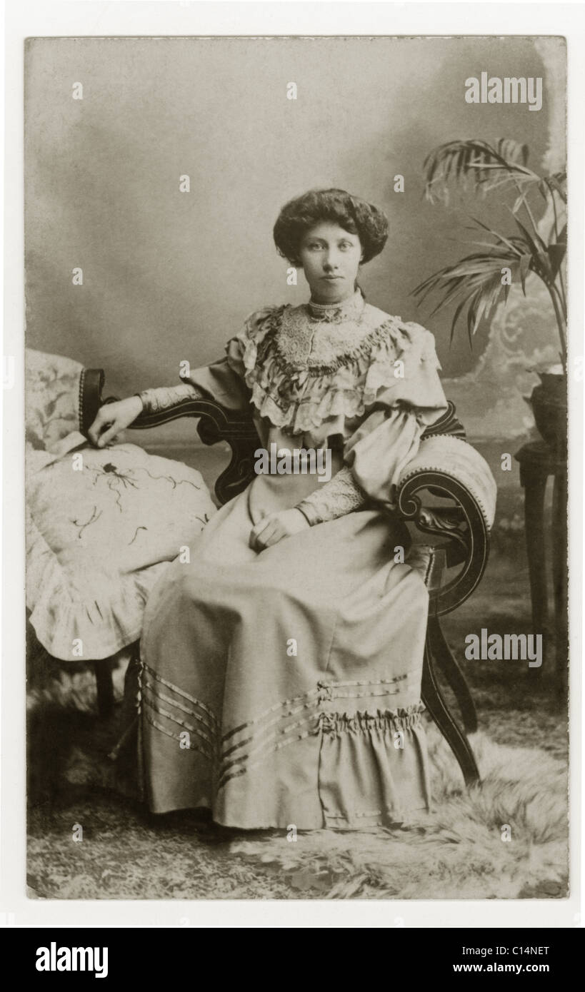 Studio portrait of pretty young Edwardian lady, wearing a skirt, blouse with wide voluminous sleeves, dated 23 March 1906 Stock Photo
