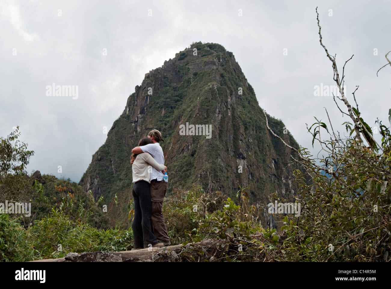 A young man asks for a young woman's hand in marriage in the ruins of Machu Picchu. Stock Photo
