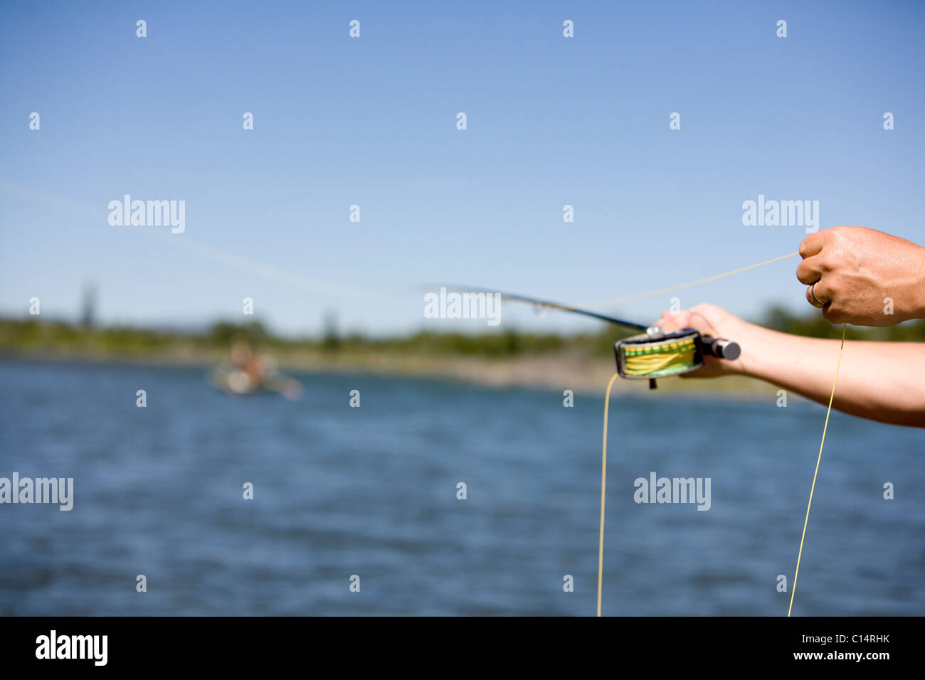 A short focus view of a fly fishing cast with the Snake River in the background. Stock Photo