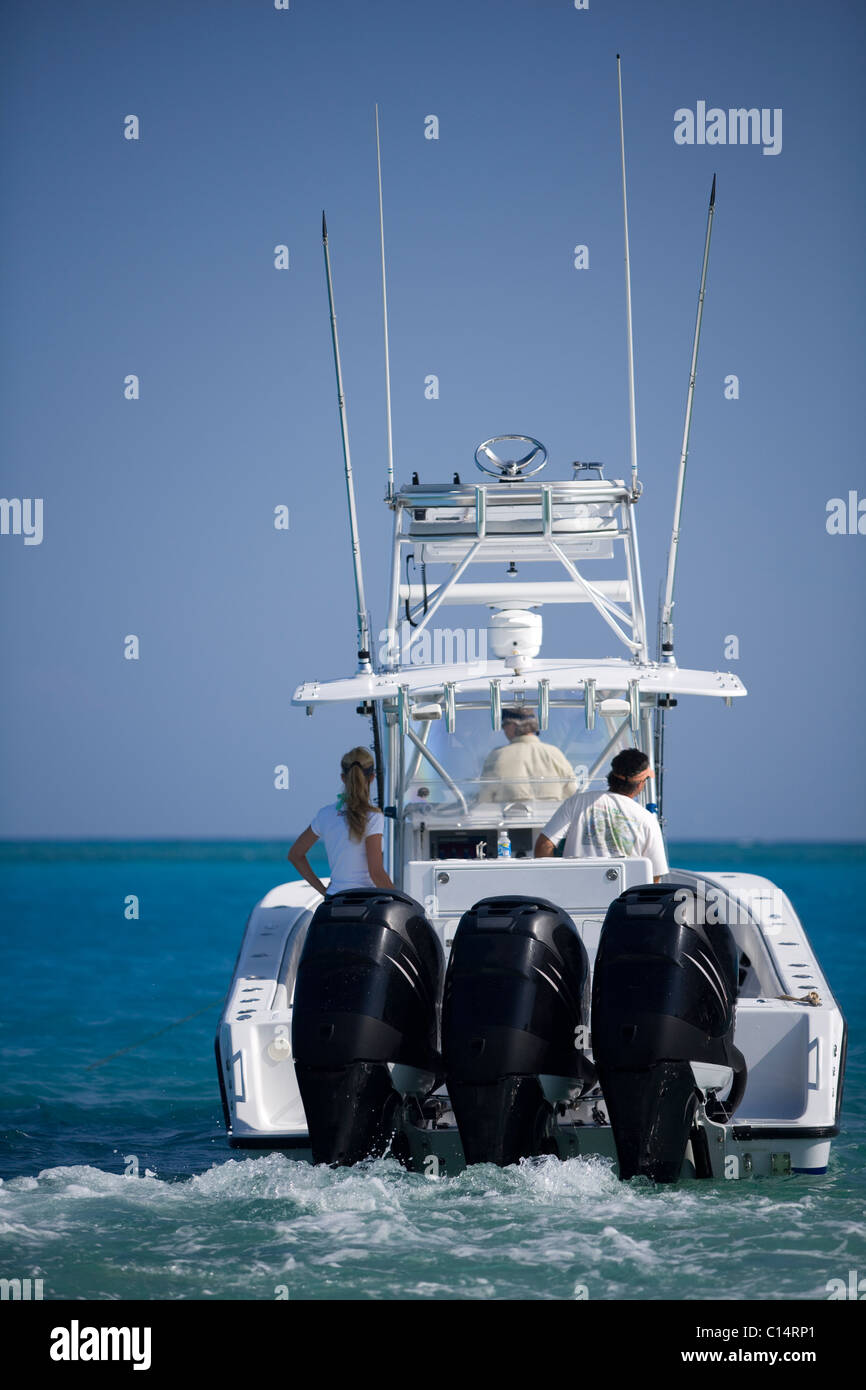 A fishing boat heads out to blue water for a day of deep sea fishing. Stock Photo