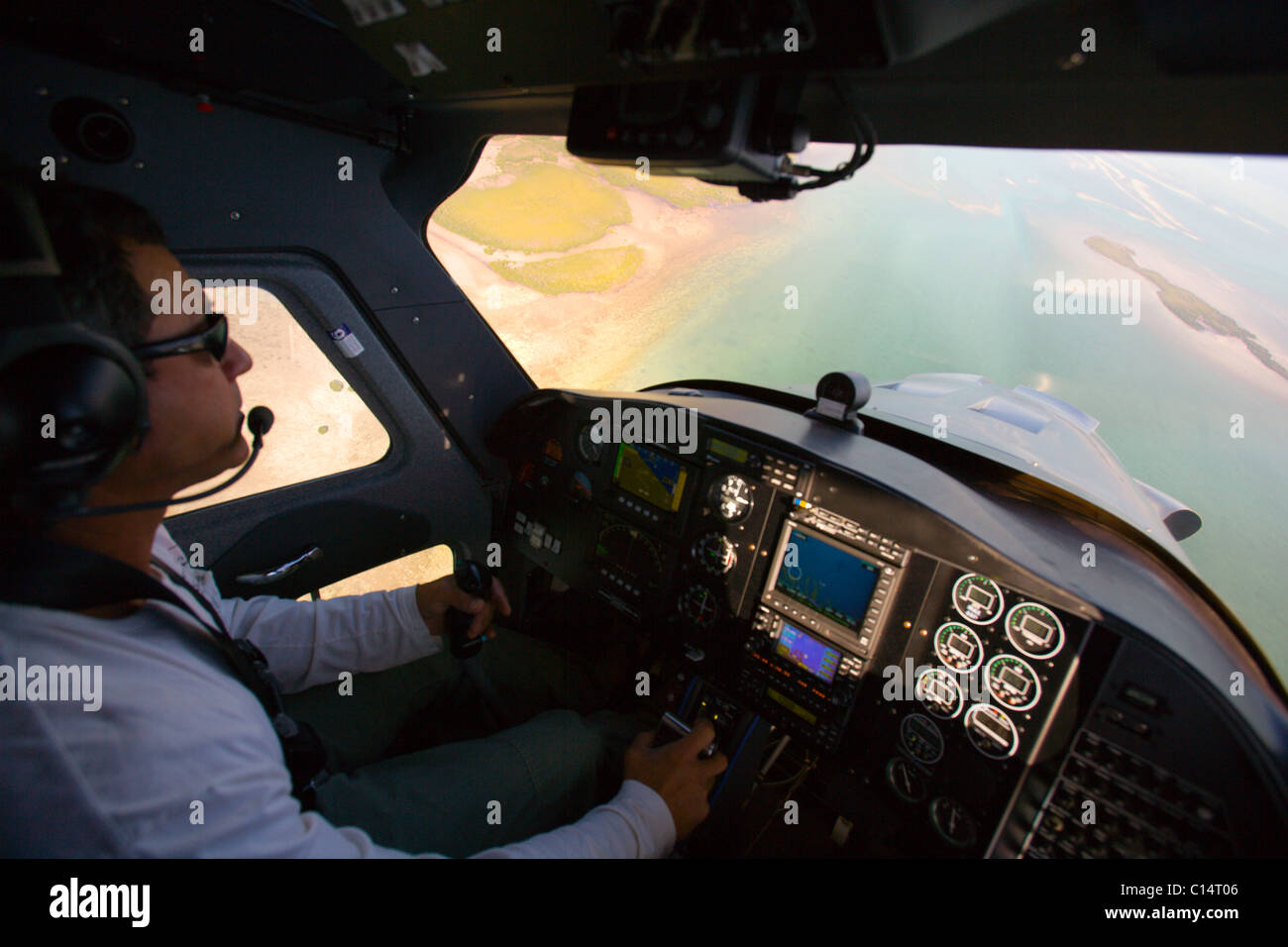 A cockpit view of a pilot looking down at the florida keys. Stock Photo