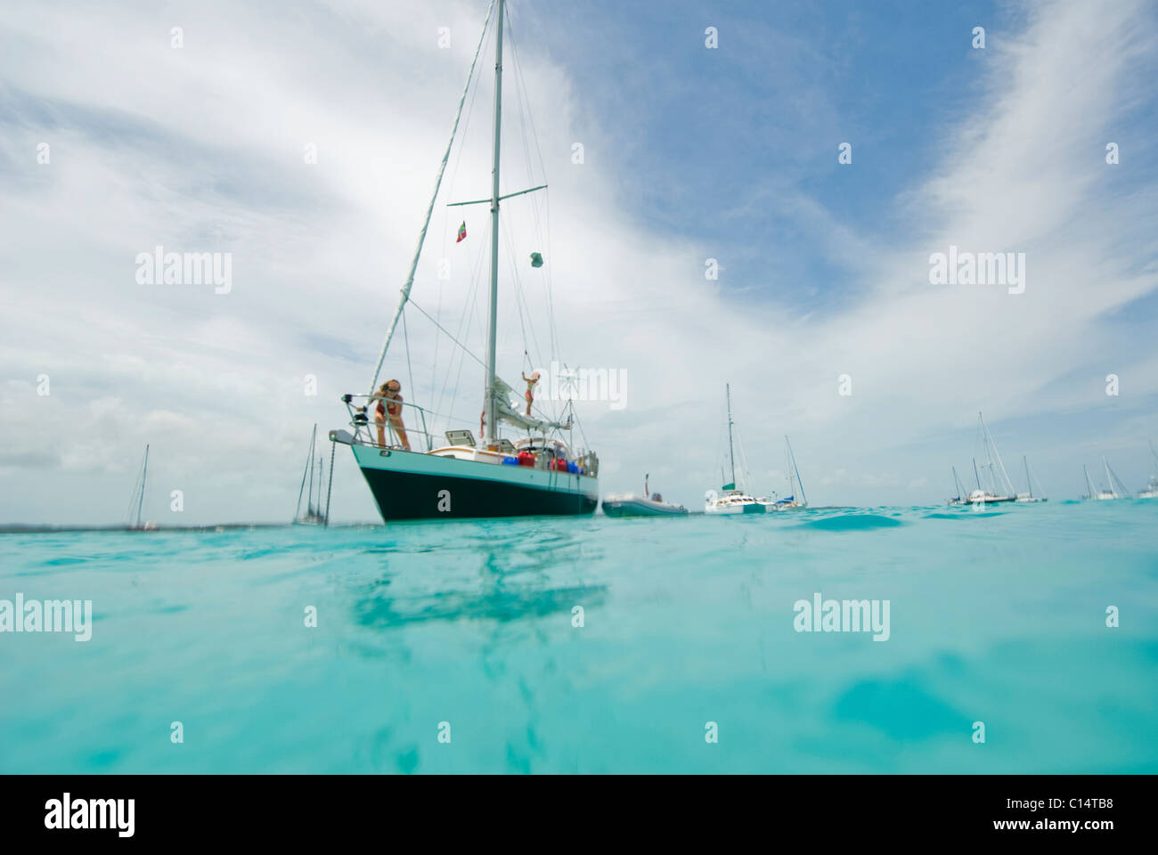 A family anchoring in the harbor after a day sail in Georgetown, Exumas Stock Photo