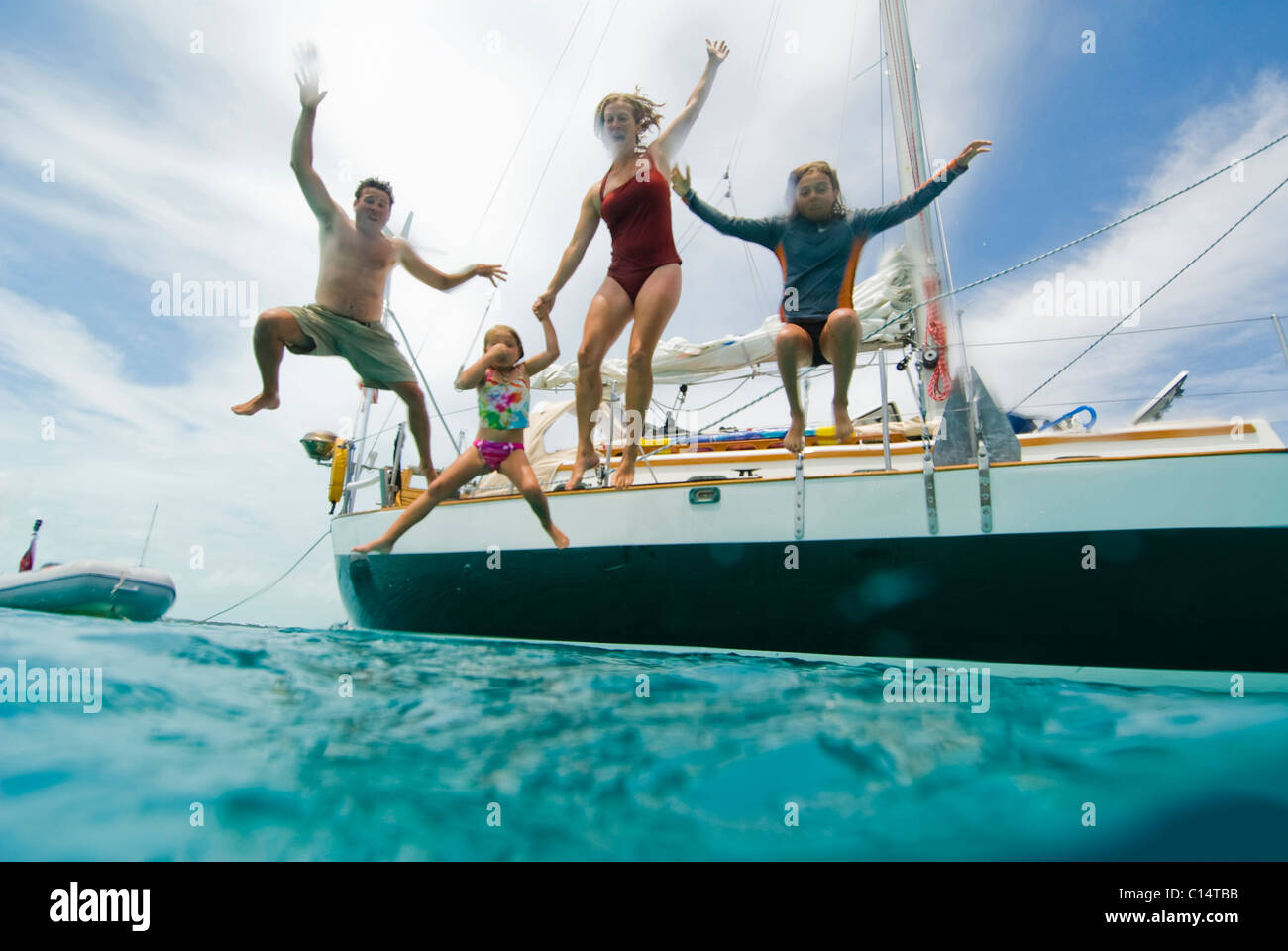 A family jumping off their boat Stock Photo Alamy