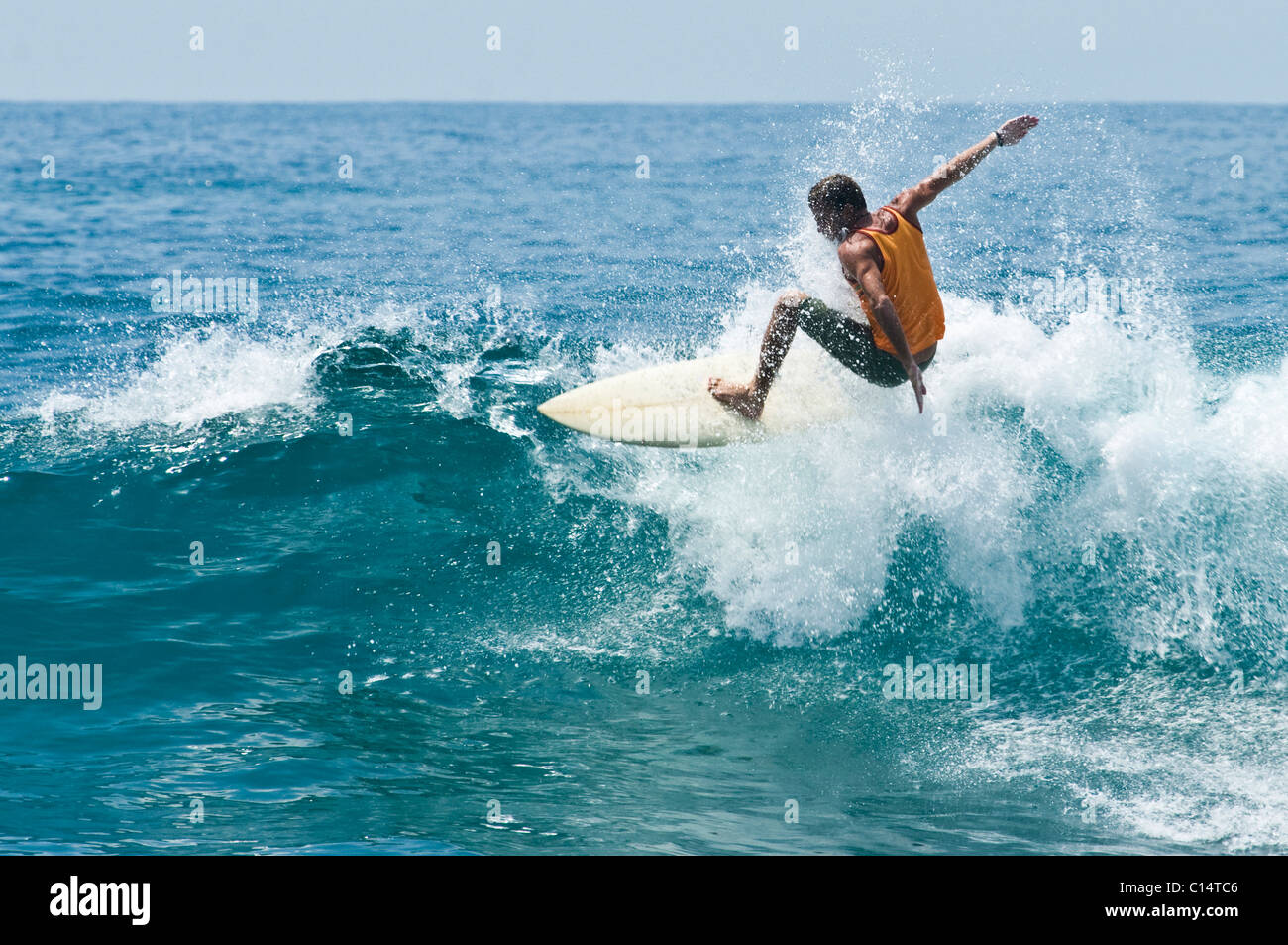 A young man surfing in Costa Rica Stock Photo