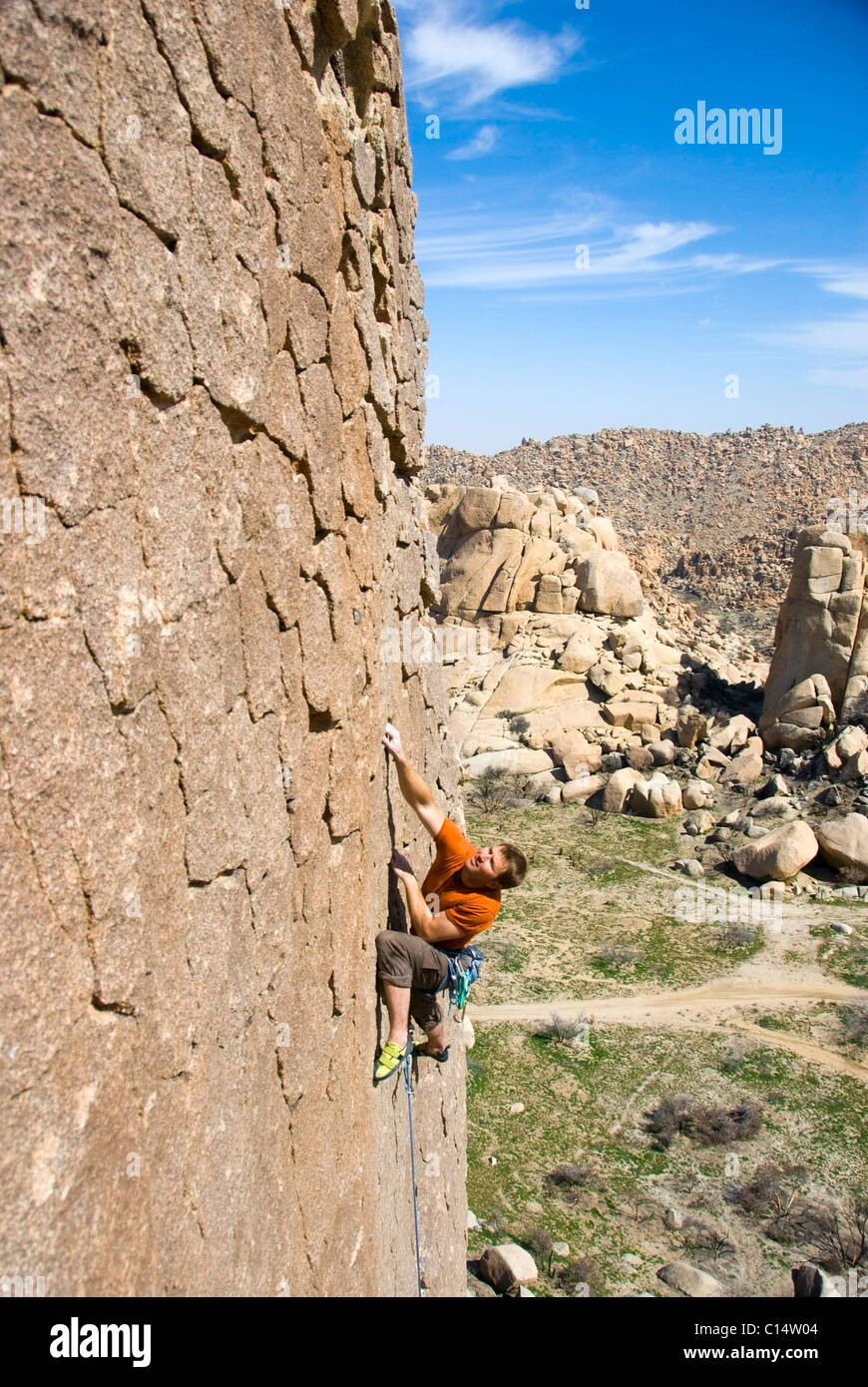 A rock climber climbs a vertical sport route in the Valley of the Moon