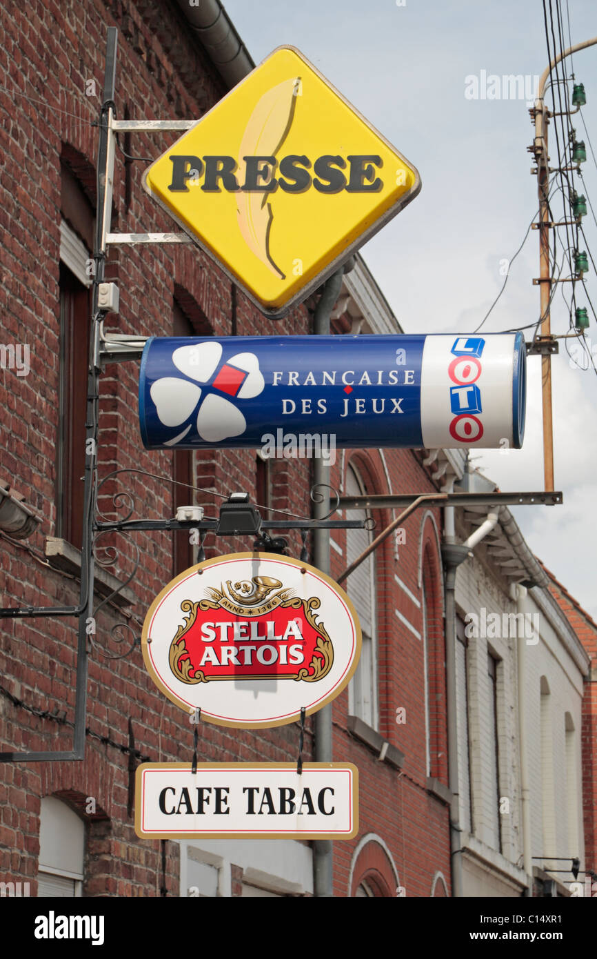 Assorted advertising signs above a Cafe in the pretty small French village of Morbecque, Nord-Pas-de-Calais, France. Stock Photo