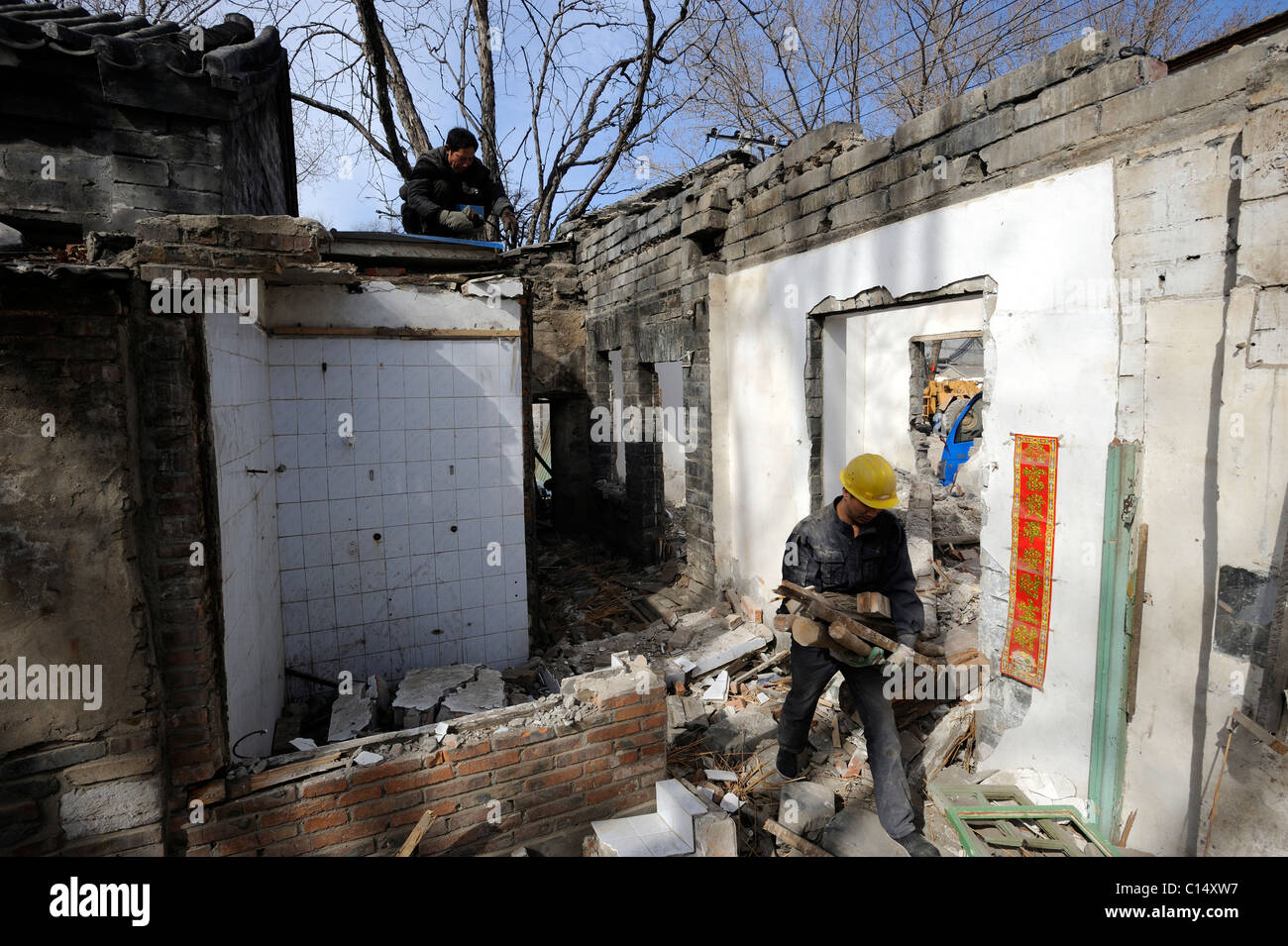 Chinese workers demolish an old buildings abutting on Zhongnanhai - headquarters of Chinese government in Beijing. 06-Mar-2011 Stock Photo