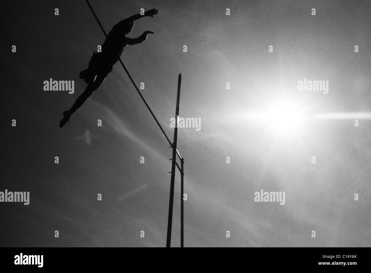 Silhouette of a pole vaulter in action. Stock Photo