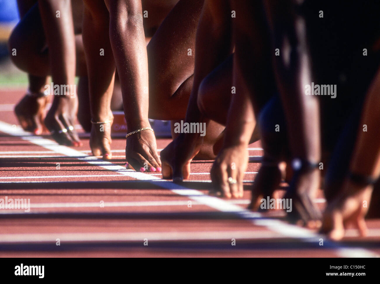 Detail at the starting line of a women's 100 meter sprint race. Stock Photo