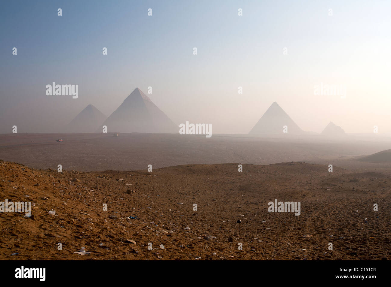 Smoke and haze from burning rubbish constantly cloak Giza's Pyramids as trash controls fail Stock Photo