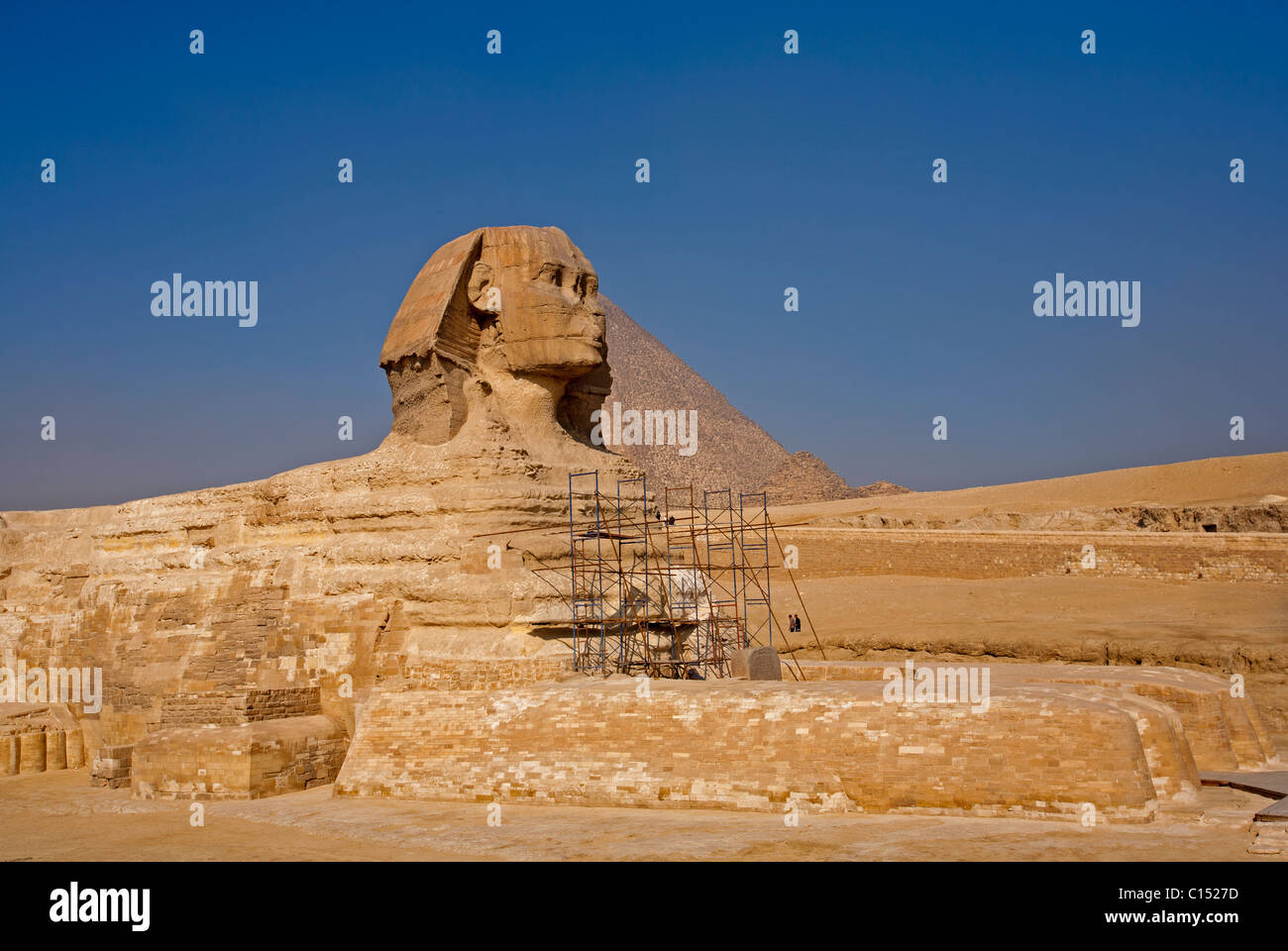 The morning smoke clears to view both the Great Sphinx of Giza and the Pyramid of Khufu (Cheops) in Egypt Stock Photo