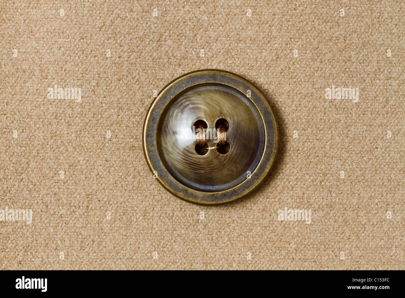 Big button fixed on fabric background Stock Photo