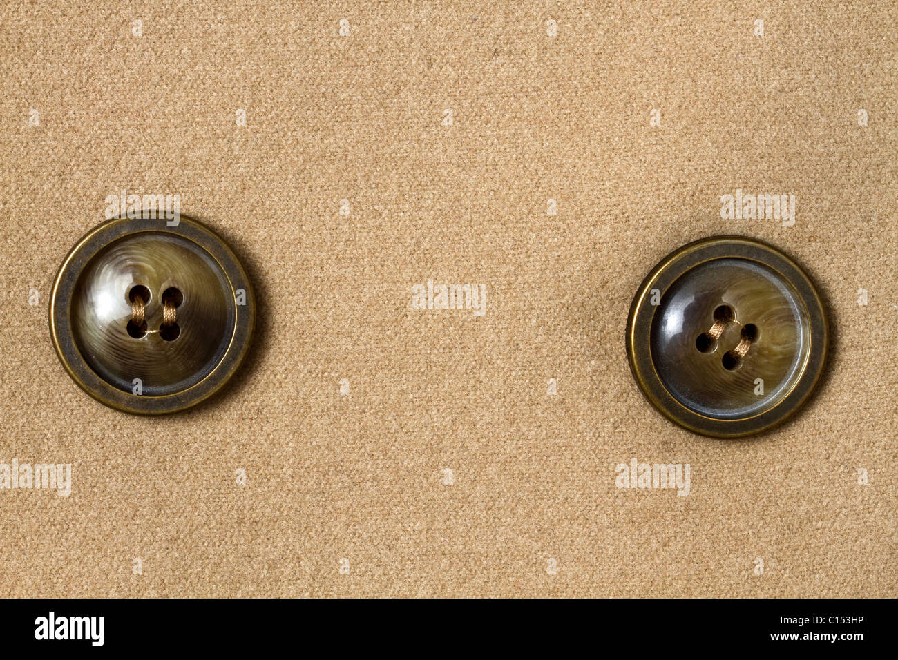 Two big buttons fixed on fabric background Stock Photo