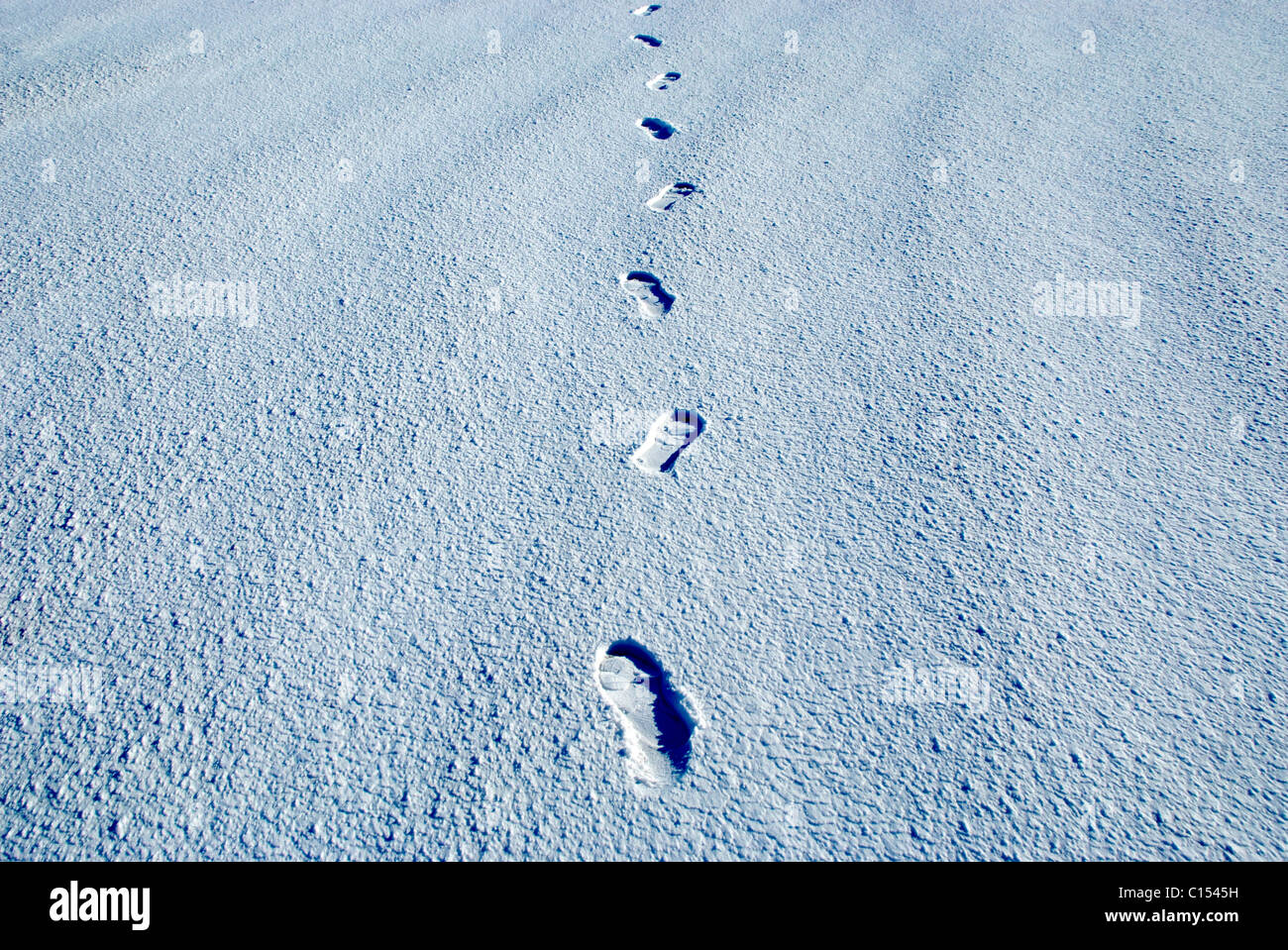 footsteps in the snow and ice in winter. Stock Photo