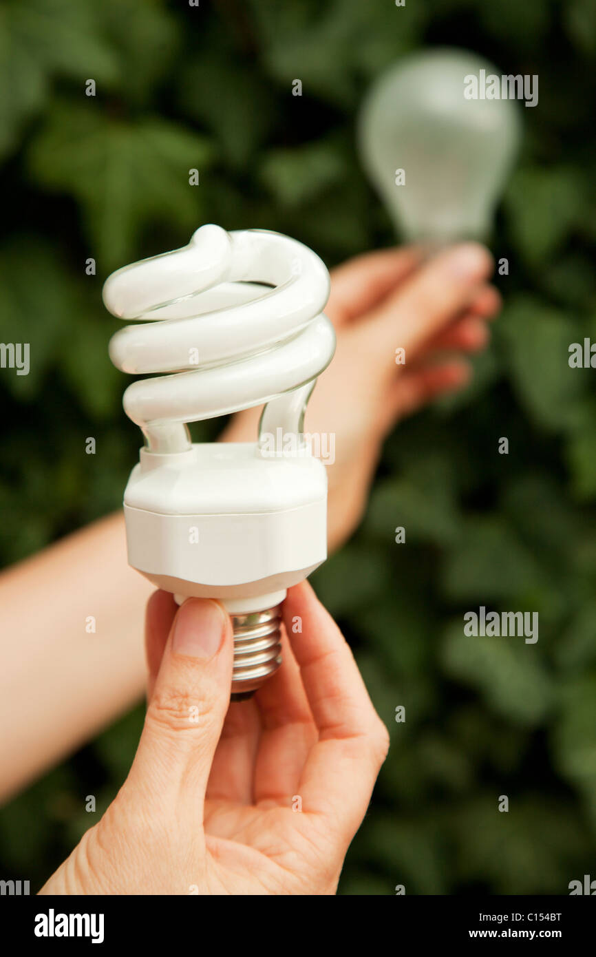 New energy saving lamp and old light bulb Stock Photo - Alamy