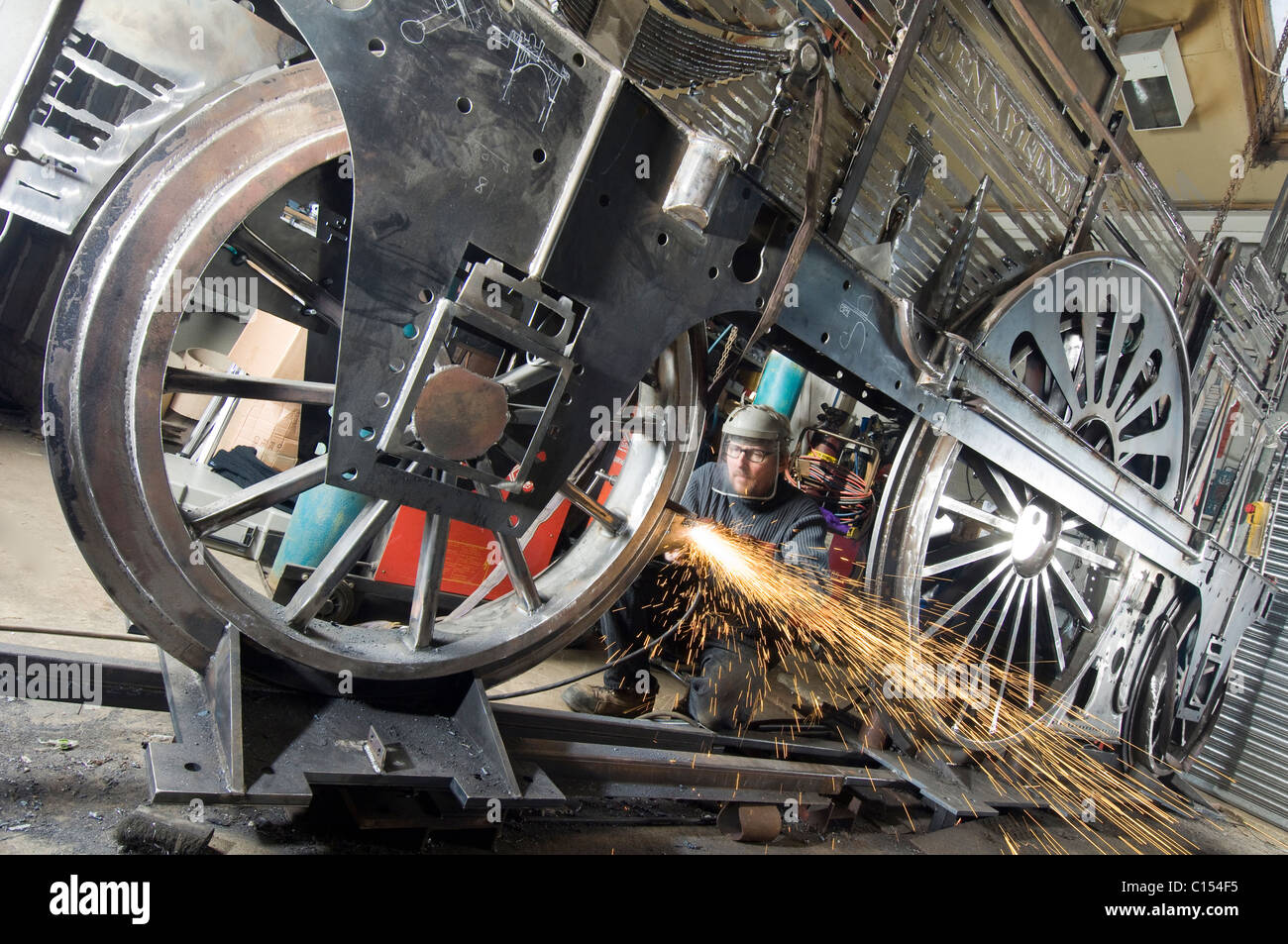 Sculptor Jon Mills welds the frame of his lifesize two-dimensional artwork based on the steam train 'Jenny Lind' Stock Photo