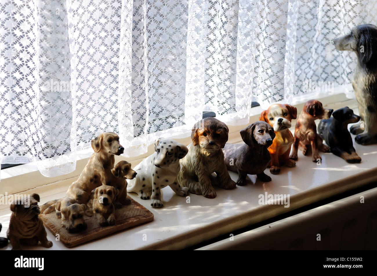 Ornamental Pot Dogs On Window sill . Stock Photo