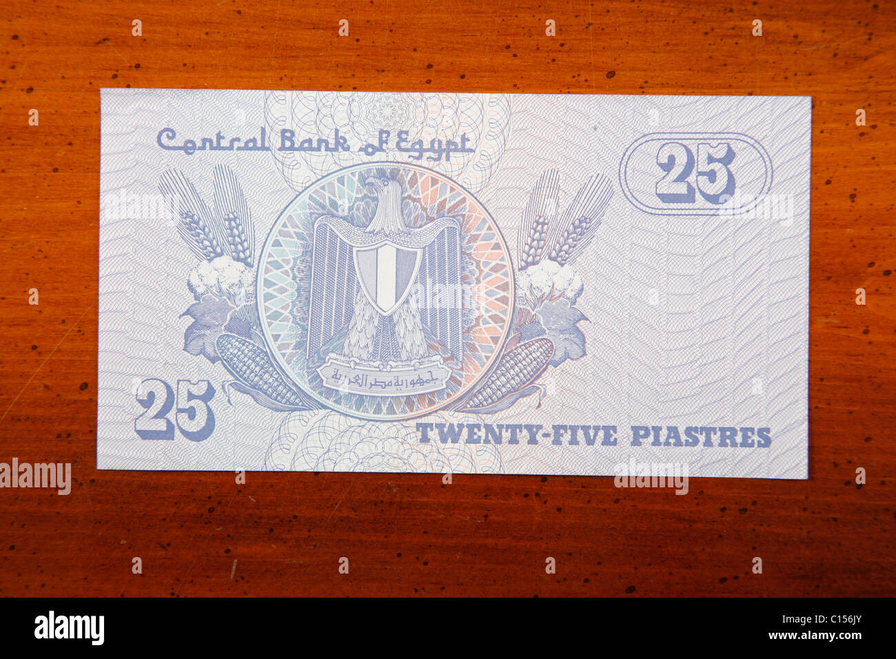 Egyptian 25 Piastres currency note on table with English script showing Egyptian Coat of Arms Stock Photo