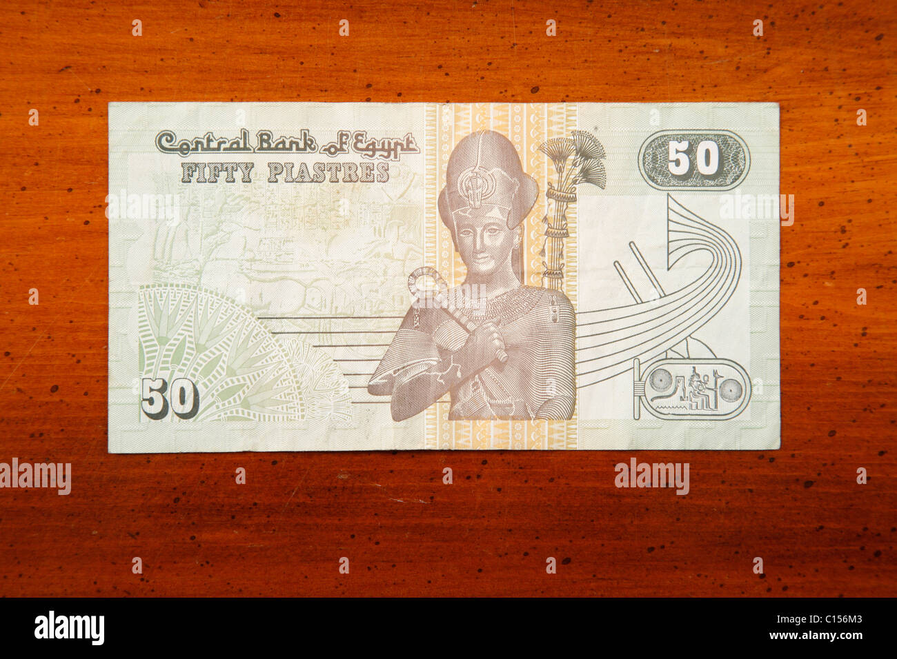 Egyptian 50 Piastres currency note on table with English script showing pharoh Stock Photo