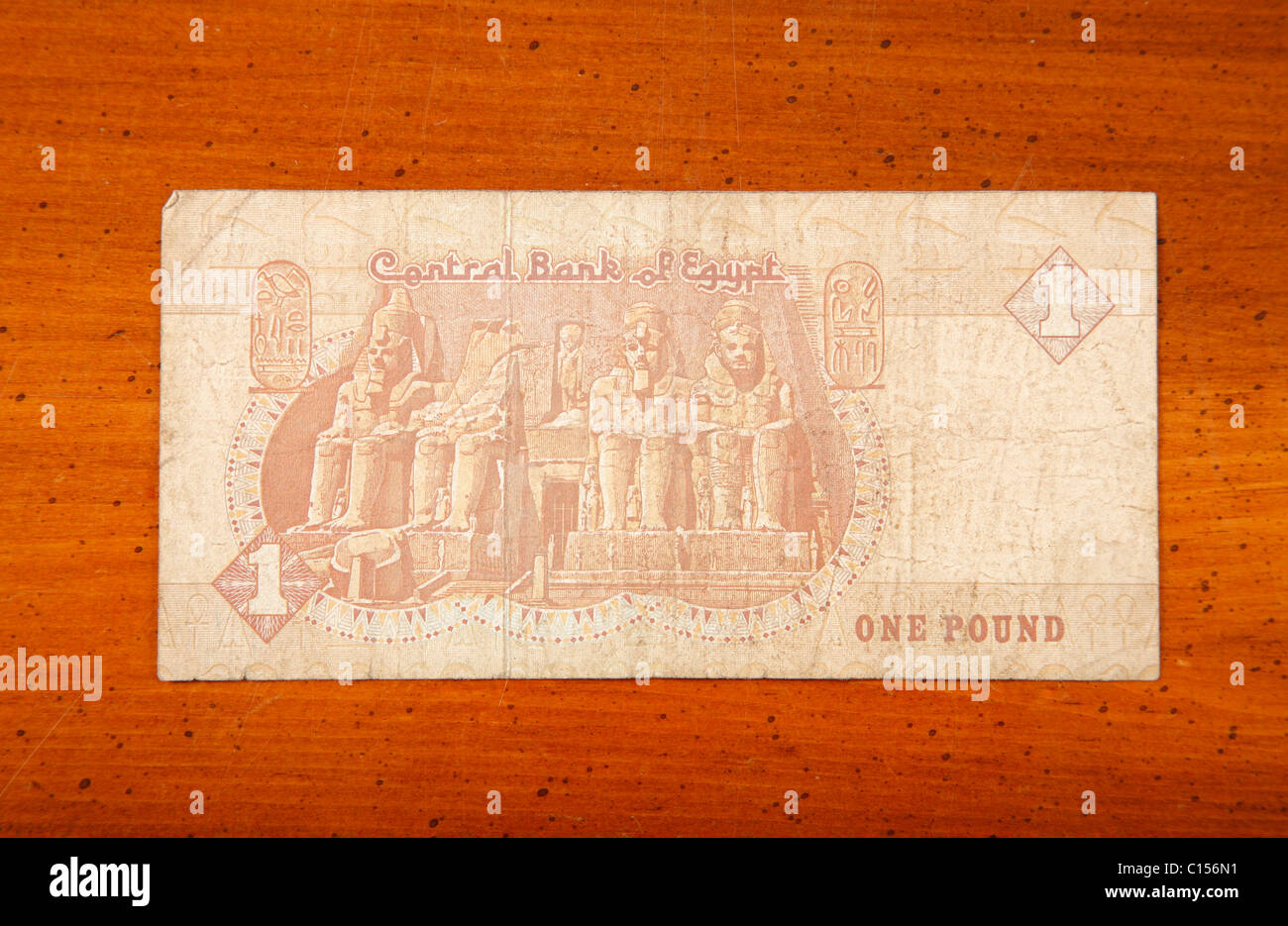 Egyptian one pound currency note on table with English script showing Abu Simbel Stock Photo