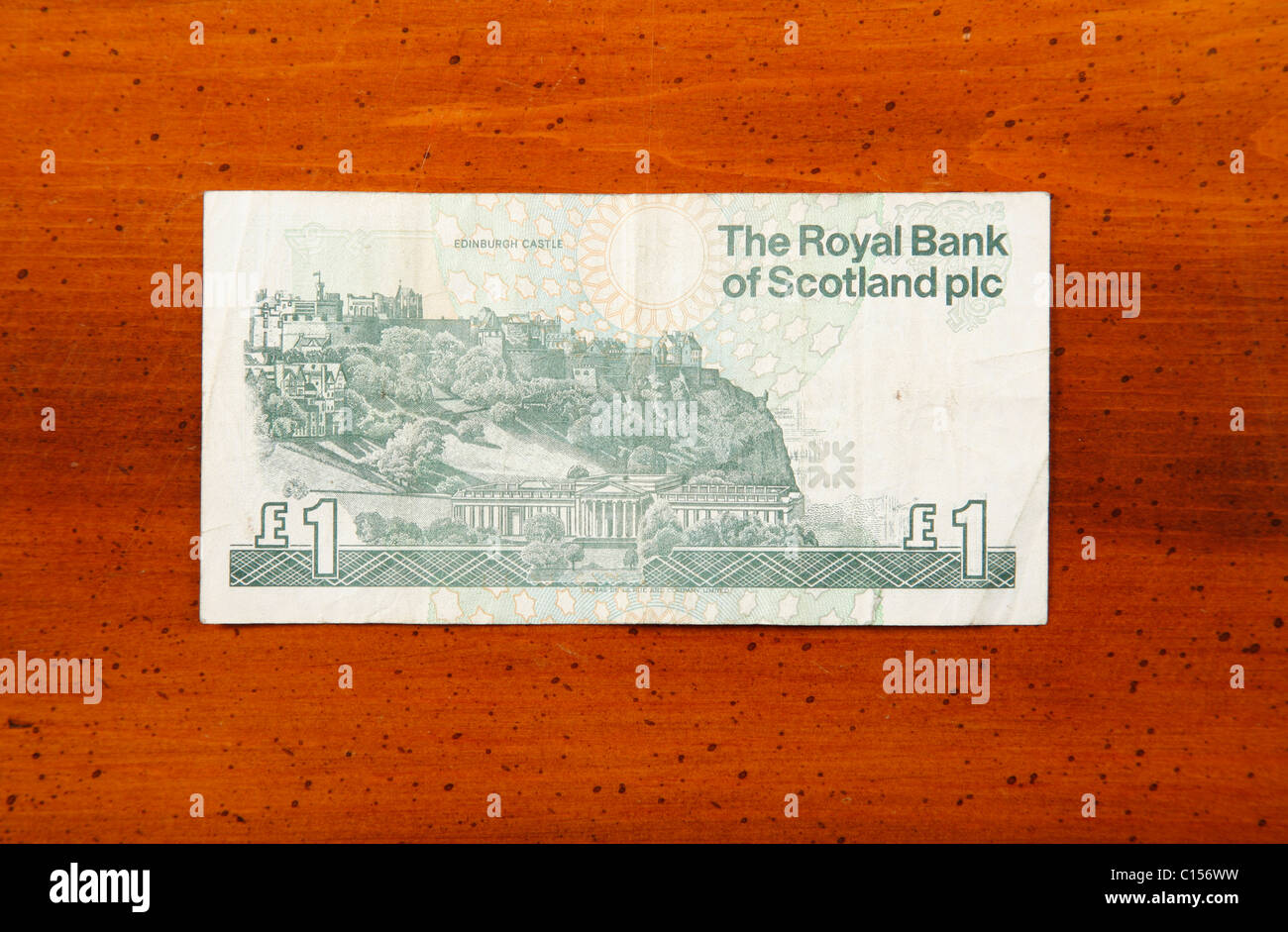 One pound Scottish currency note on table showing print of Edinburgh Castle Stock Photo