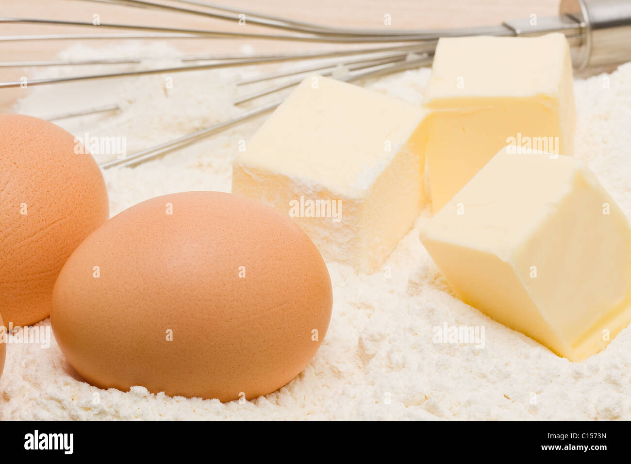 Flour, eggs and butter with egg whip Stock Photo