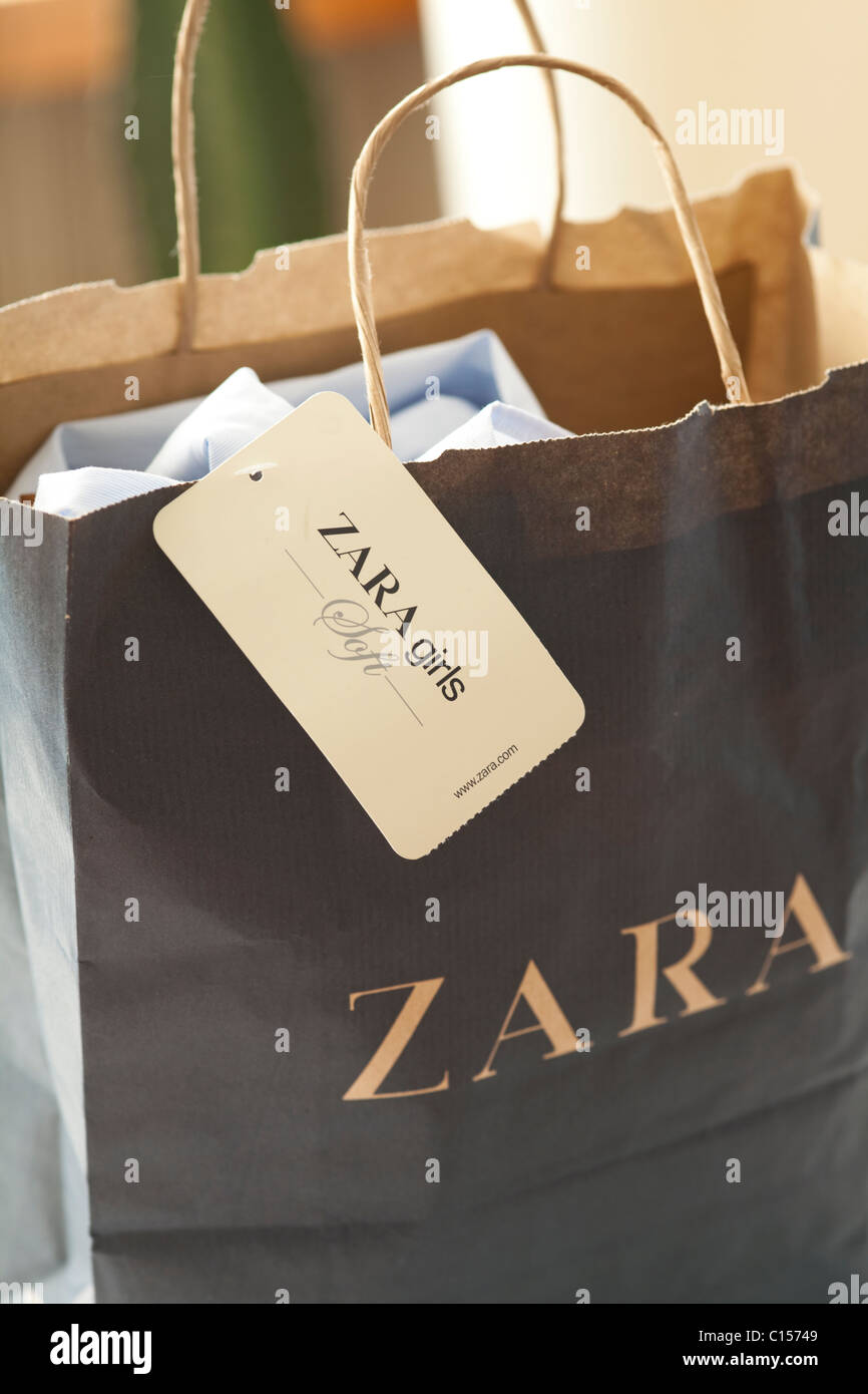 Zara shopping bag with clothes inside Stock Photo - Alamy