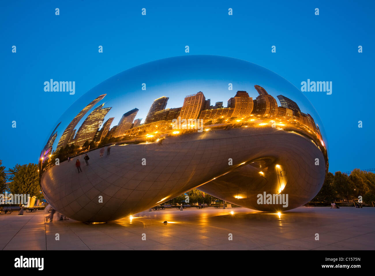 City reflected in Cloud Gate sculpture in Millennium Park, at dusk ...