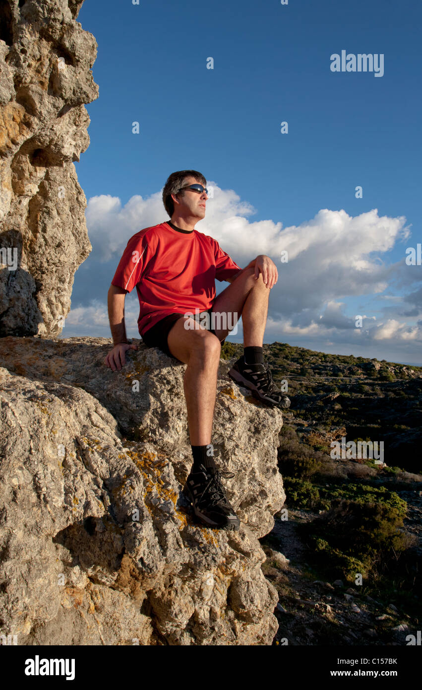 Old man sitting on rock hi-res stock photography and images - Alamy
