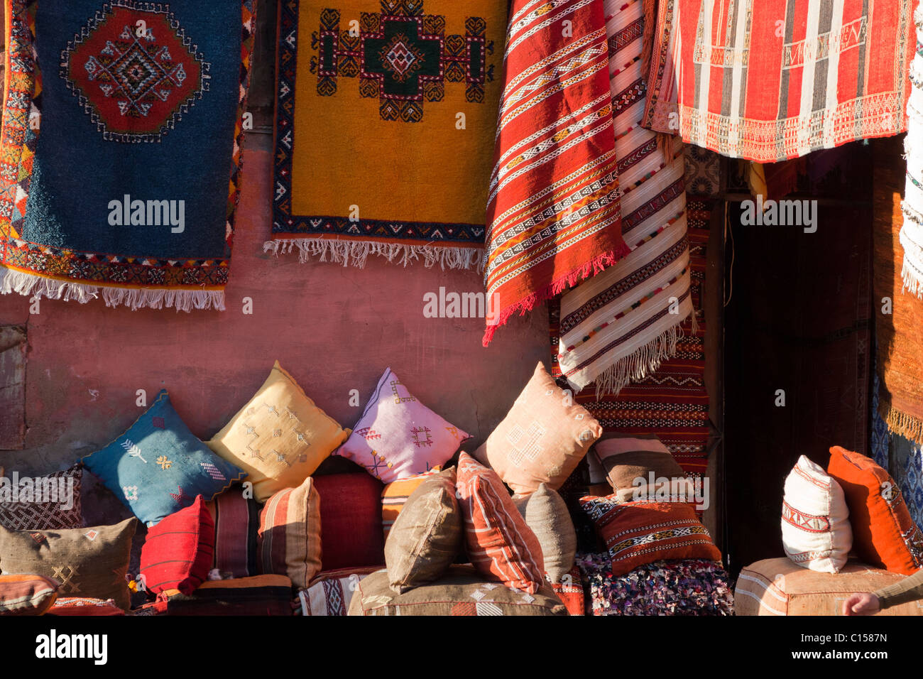 Carpets and cushions for sale in a Marrakesh souk Stock Photo