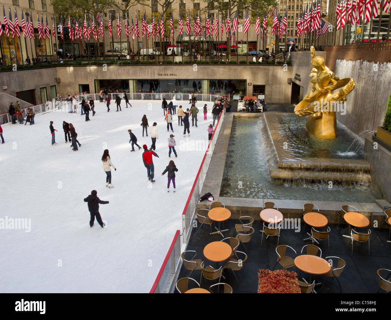 Skaters at ice rink at Rockefeller Center in mid town Manhattan. Stock Photo