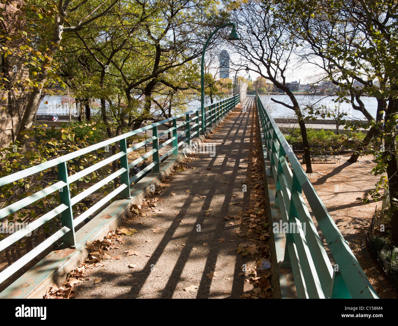 Walkway over urban park along East River Drive in Manhattan. Stock Photo