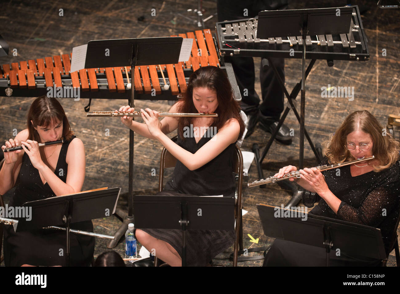 Overhead view of flutes and piccolo performing in classical orchestra