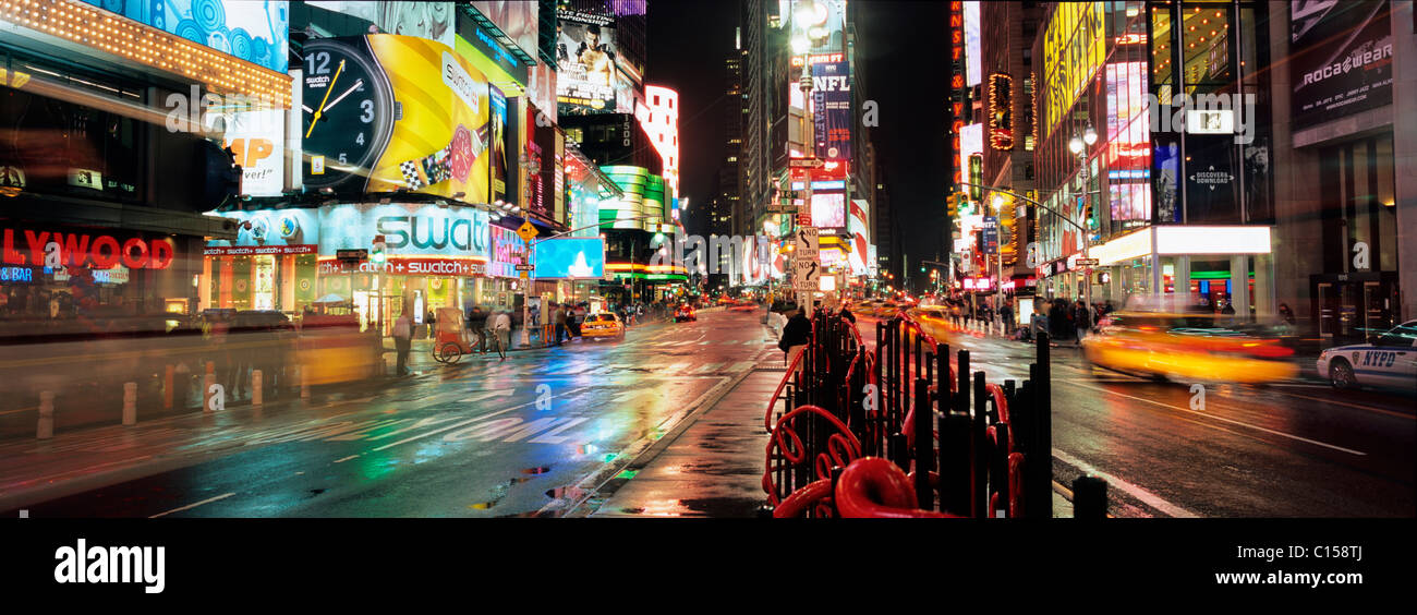 Neon advertising hoardings, tourists and traffic at Times Square Stock Photo