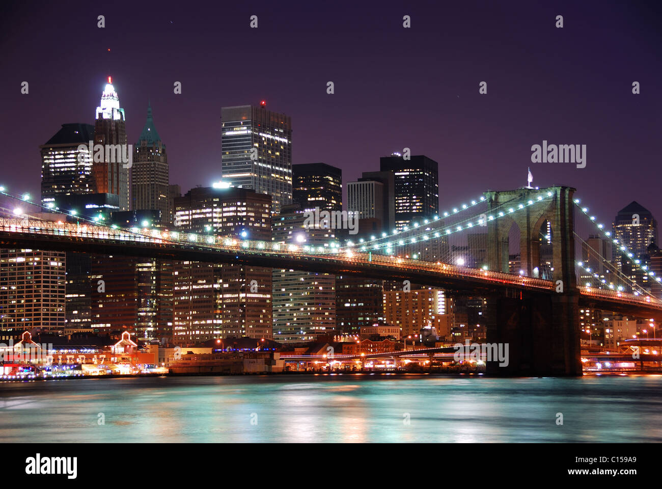 New York City Manhattan skyline night scene with Brooklyn Bridge over ...