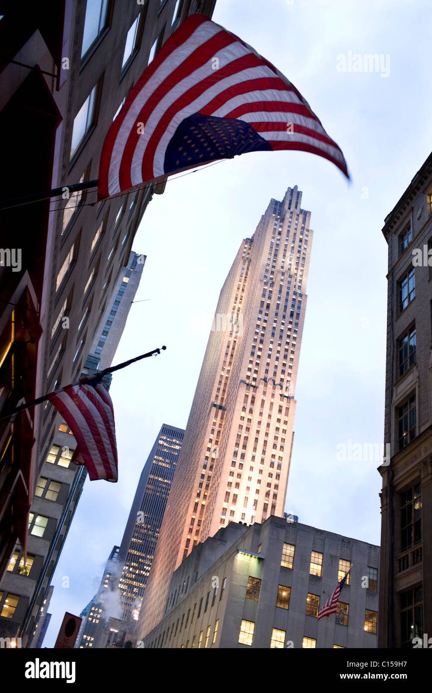 The Rockefeller Centre at night with the American flag in front Stock Photo