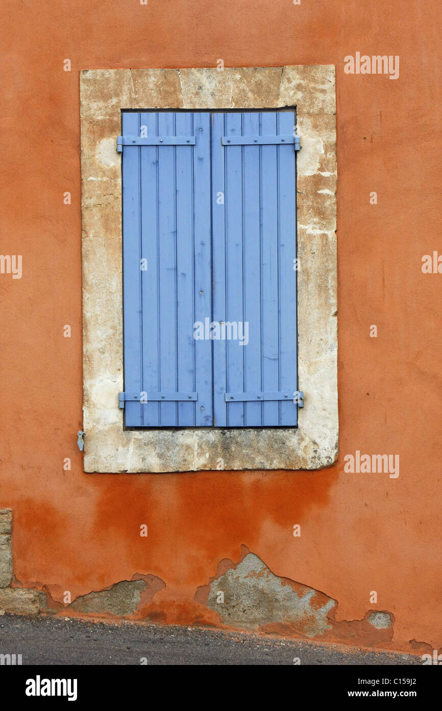 Closed blue house shutters on an old house in rural France. Stock Photo