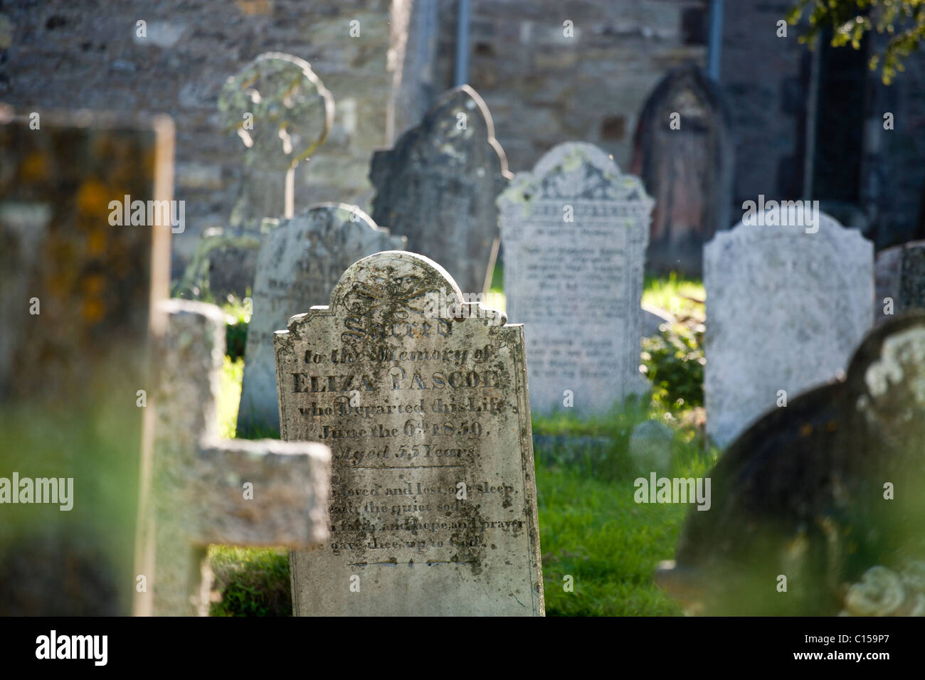 Old Mylor Graveyard. Stones scattered through the old graveyard at Mylor. Mylor, Cornwall, United Kingdom Stock Photo