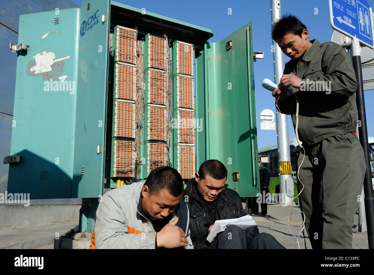 Chinese workers from CNC(China Netcom) check telephone lines in Beijing, China. 09-Mar-2011 Stock Photo