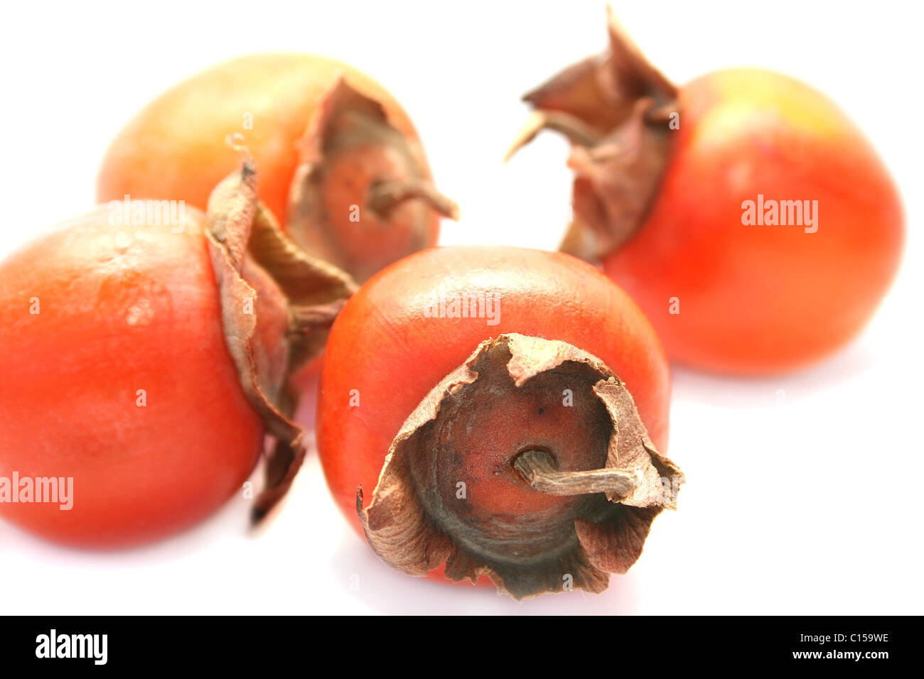 Ripe persimmons isolated on white background Stock Photo - Alamy