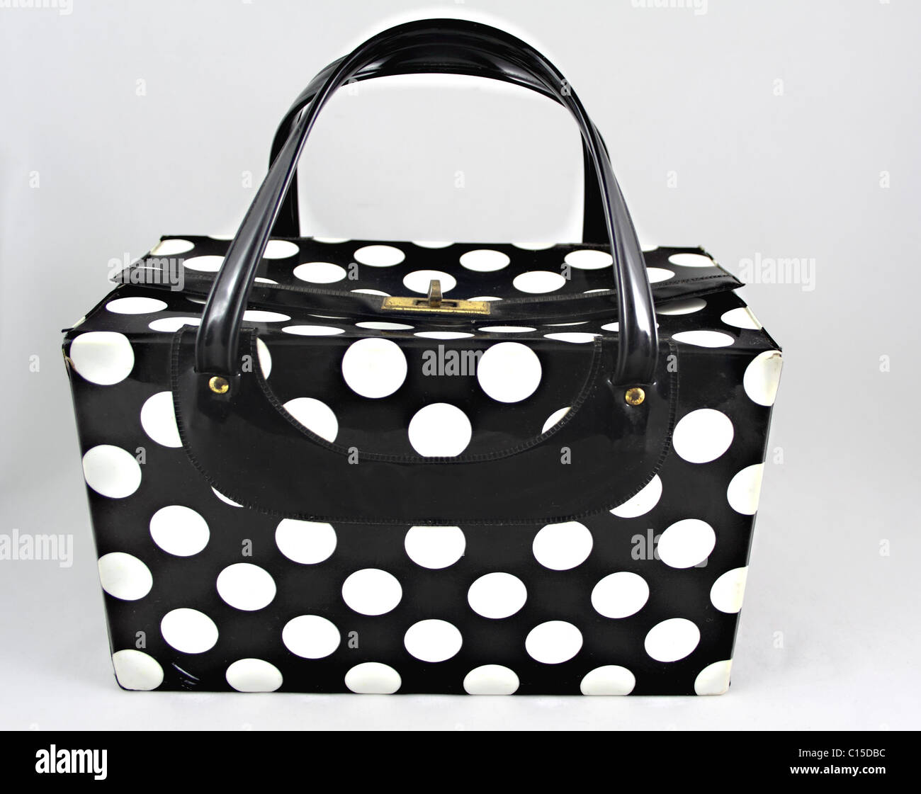 Polka dot, vanity case with plastic black handles and gold colored lock. Stock Photo